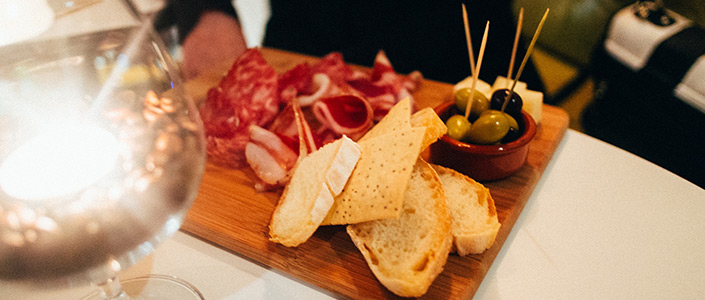 Enjoying tapas with cured ham jamón